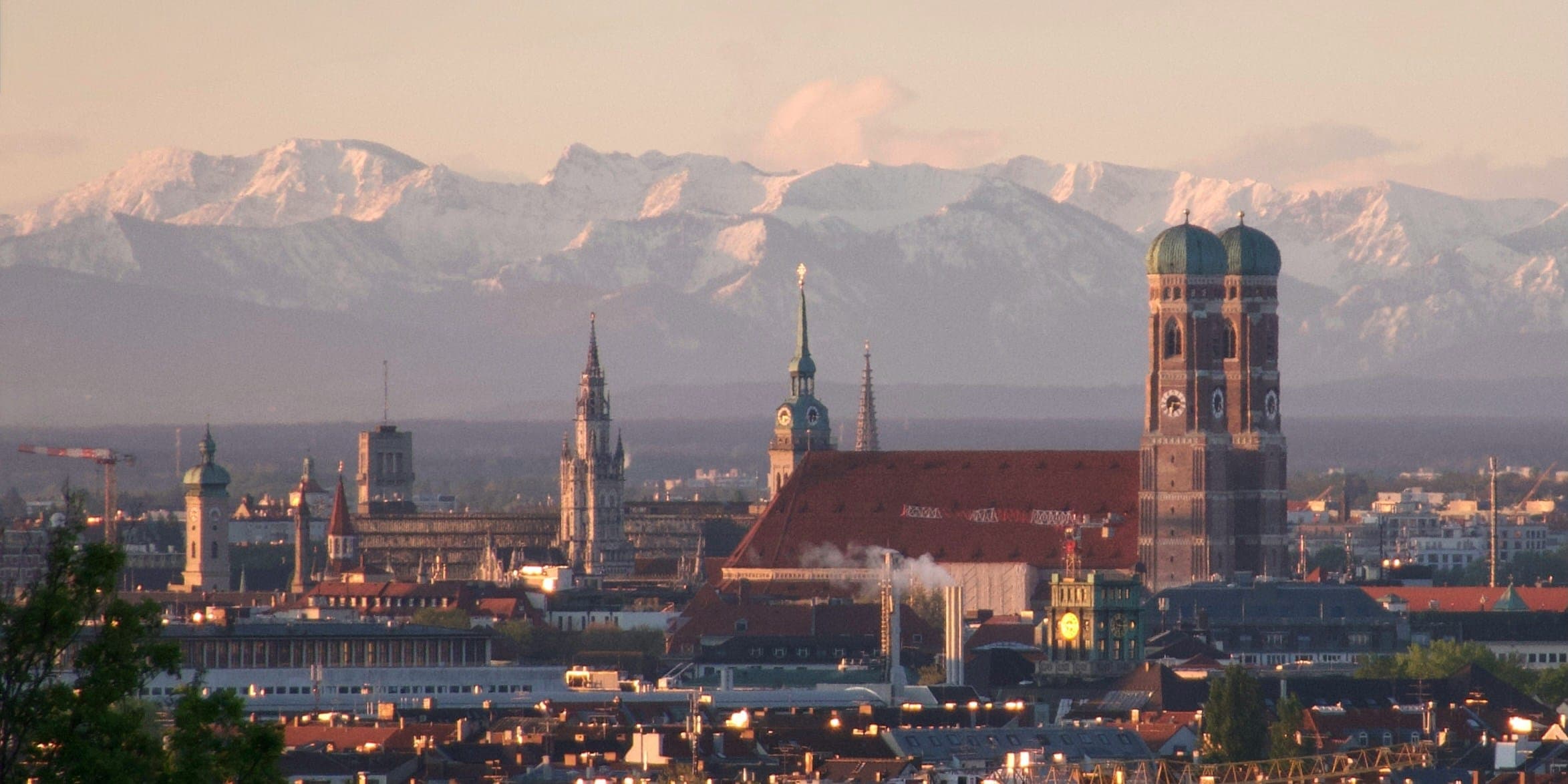 Munich's old town with the Frauenkirche against the Alps